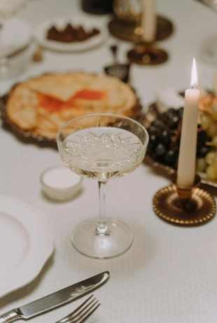 Table set with fine cutlery and wedding meal with glass and candle at The Shelborne Hotel