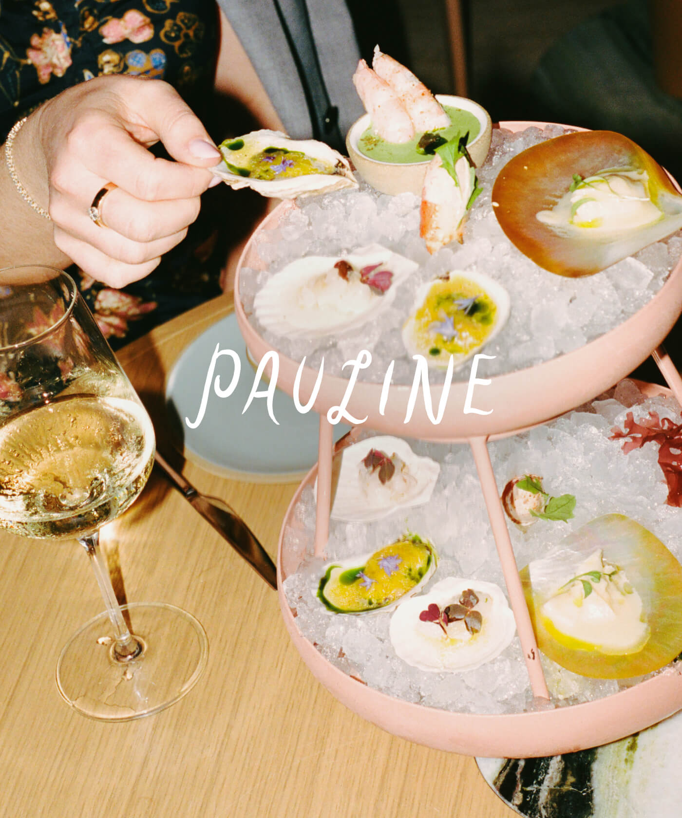 Pauline seafood tower with oysters, crab, and wine